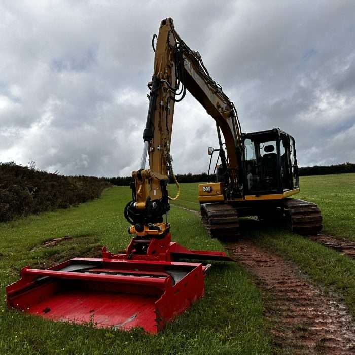 Red Turf Cutting Bucket Attached to CAT 309 Excavator