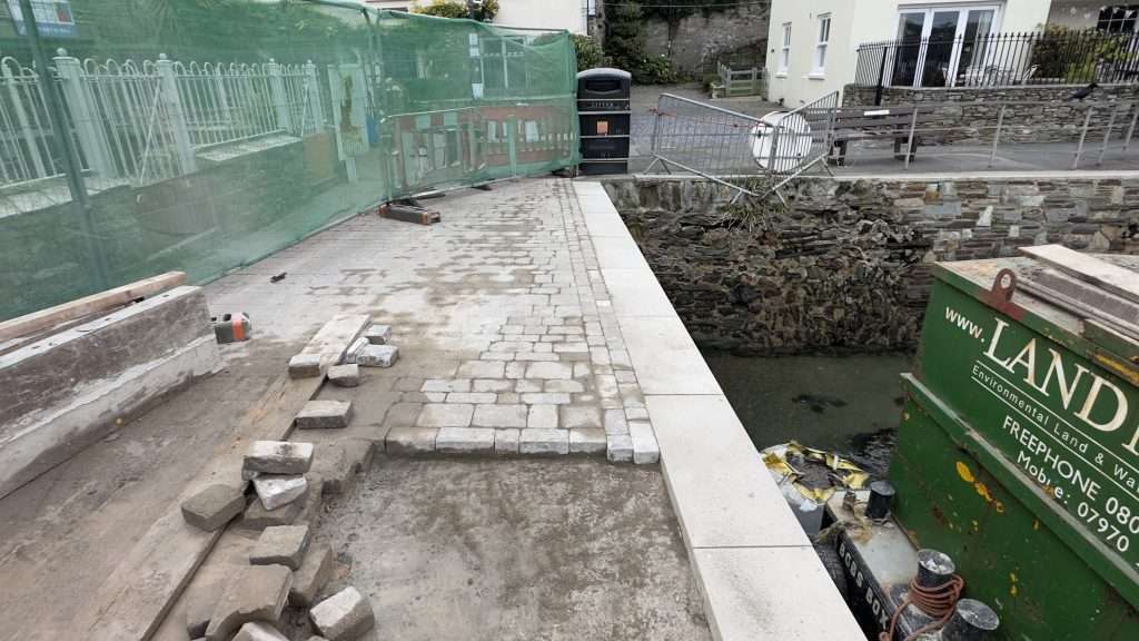 Laying replacement cobbles on quay wall