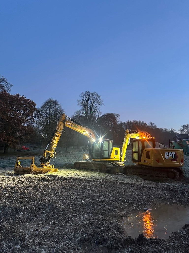 Caterpillar excavator with lights and turf translocator head