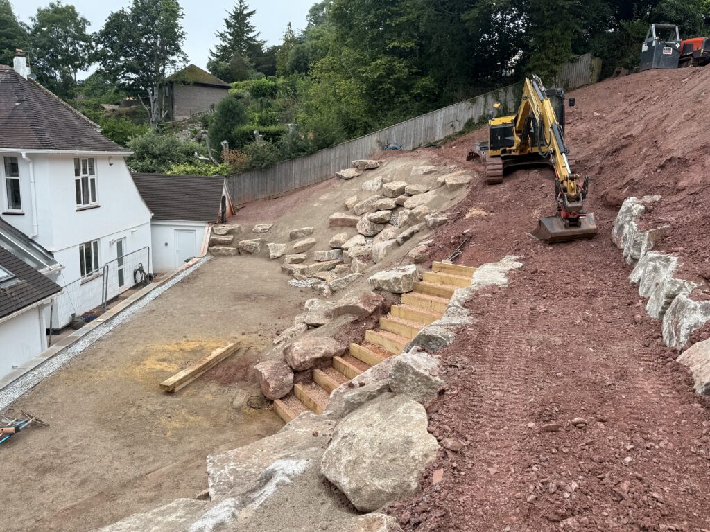 New steps and bank being graded by excavatpr