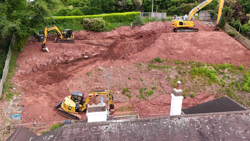 Long reach excavator for soil removal